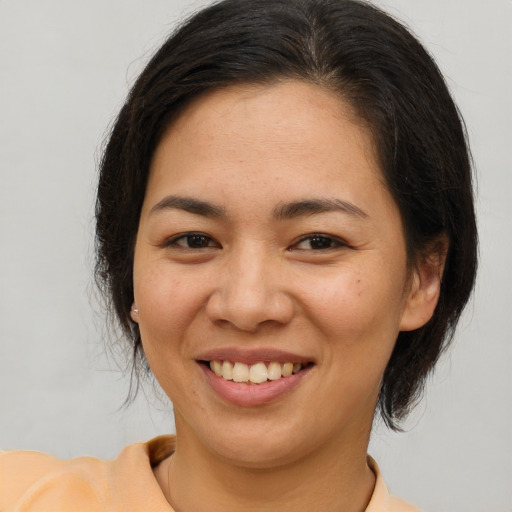 Joyful white young-adult female with medium  brown hair and brown eyes
