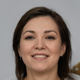 Joyful white young-adult female with medium  brown hair and brown eyes