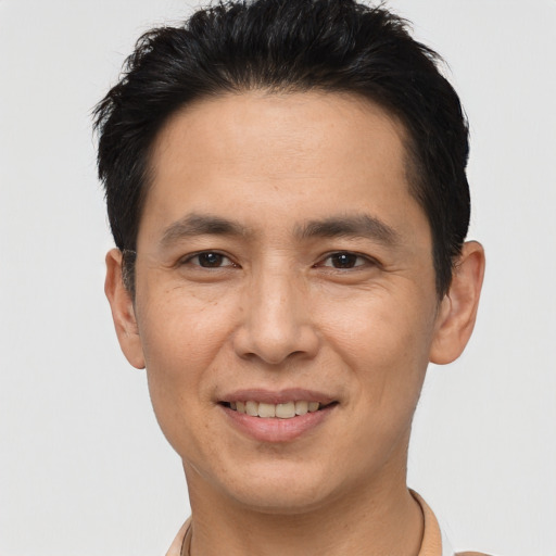 Joyful asian young-adult male with short  brown hair and brown eyes