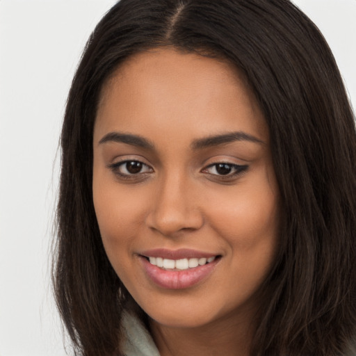 Joyful latino young-adult female with long  brown hair and brown eyes