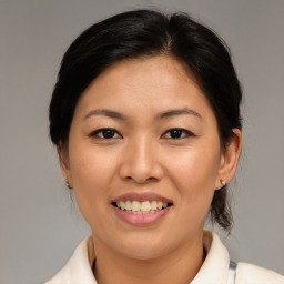 Joyful asian young-adult female with medium  brown hair and brown eyes