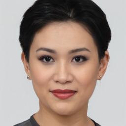 Joyful asian young-adult female with short  black hair and brown eyes