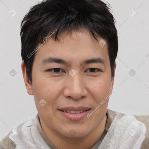 Joyful asian young-adult male with short  brown hair and brown eyes