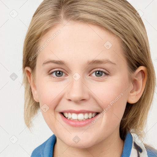 Joyful white young-adult female with medium  brown hair and blue eyes