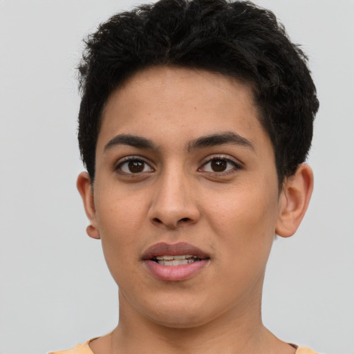 Joyful latino young-adult female with short  black hair and brown eyes
