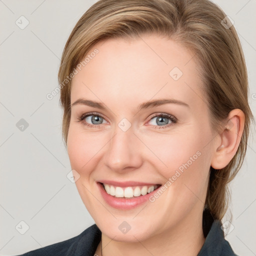 Joyful white young-adult female with medium  brown hair and grey eyes