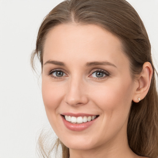 Joyful white young-adult female with long  brown hair and grey eyes