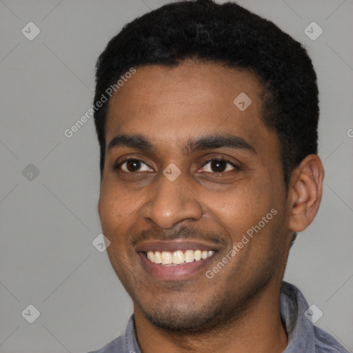 Joyful latino young-adult male with short  black hair and brown eyes