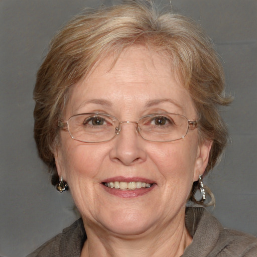 Joyful white middle-aged female with medium  brown hair and blue eyes