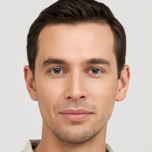 Joyful white young-adult male with short  brown hair and brown eyes