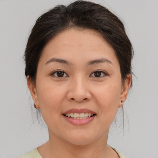 Joyful asian young-adult female with medium  brown hair and brown eyes