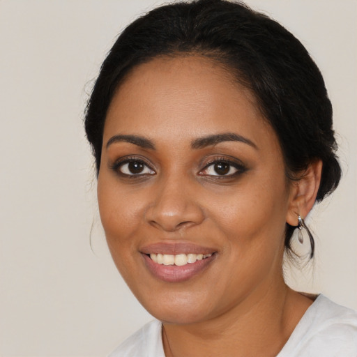 Joyful black young-adult female with medium  brown hair and brown eyes