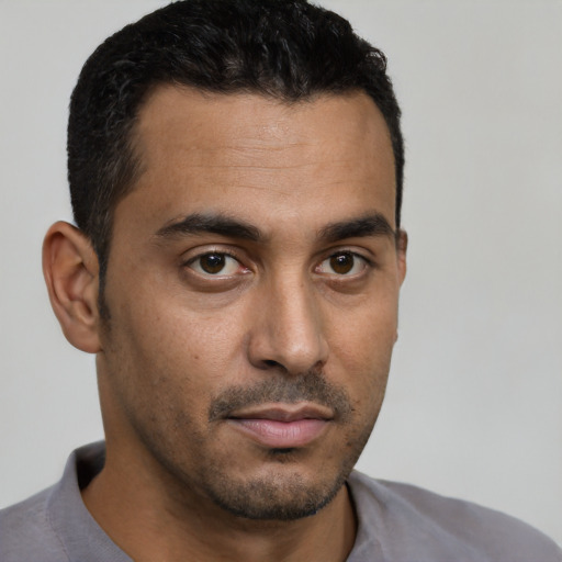 Neutral latino young-adult male with short  black hair and brown eyes