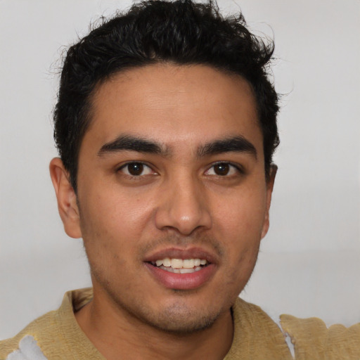 Joyful latino young-adult male with short  brown hair and brown eyes