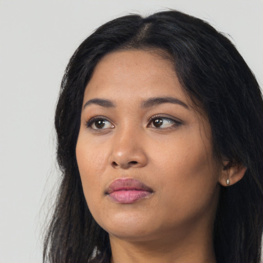 Neutral latino young-adult female with long  black hair and brown eyes