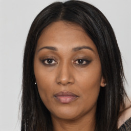 Joyful asian young-adult female with long  brown hair and brown eyes