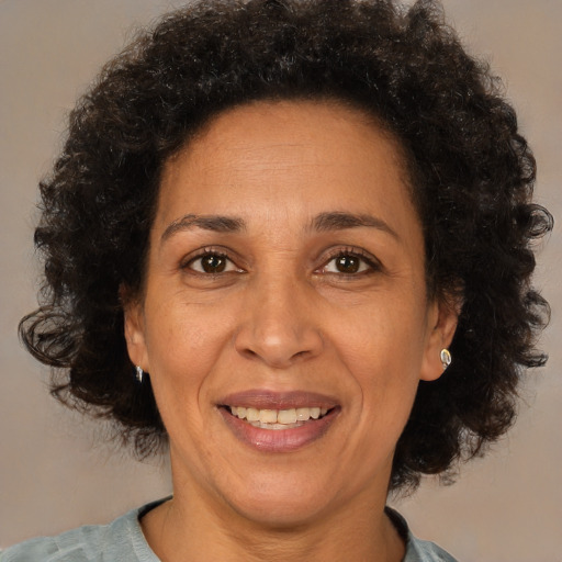 Joyful black adult female with short  brown hair and brown eyes