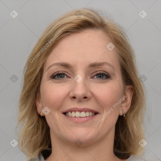 Joyful white adult female with medium  brown hair and blue eyes