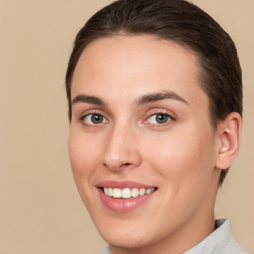 Joyful white young-adult female with short  brown hair and brown eyes