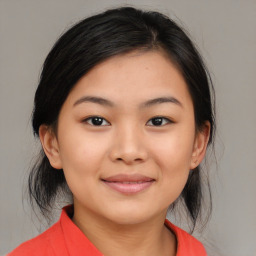 Joyful asian young-adult female with medium  black hair and brown eyes