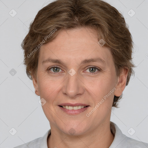 Joyful white adult female with short  brown hair and grey eyes