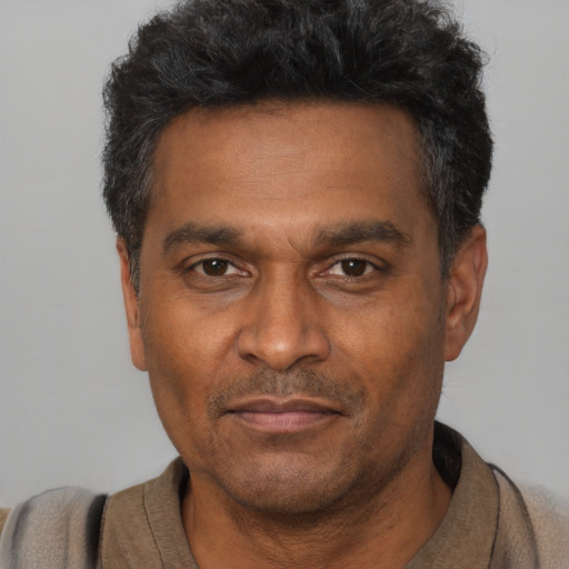 Neutral black adult male with short  black hair and brown eyes