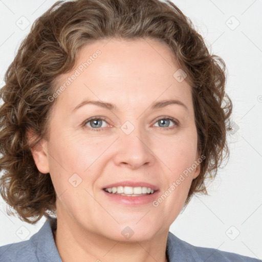 Joyful white adult female with medium  brown hair and blue eyes