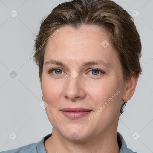 Joyful white adult female with short  brown hair and grey eyes