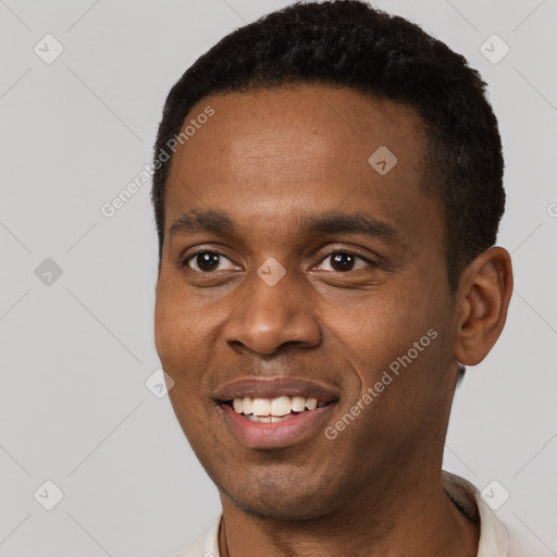 Joyful black young-adult male with short  black hair and brown eyes