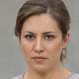 Neutral white young-adult female with medium  brown hair and grey eyes