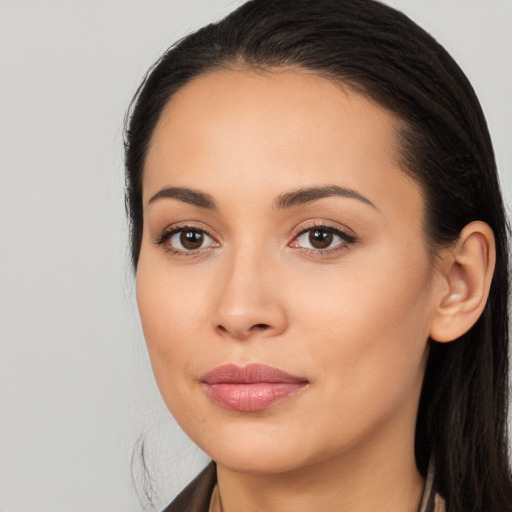 Joyful latino young-adult female with long  brown hair and brown eyes