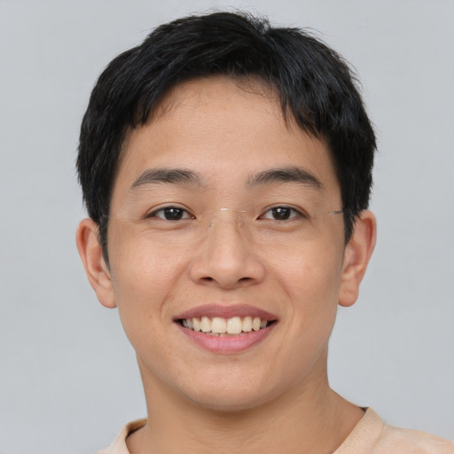 Joyful asian young-adult male with short  brown hair and brown eyes