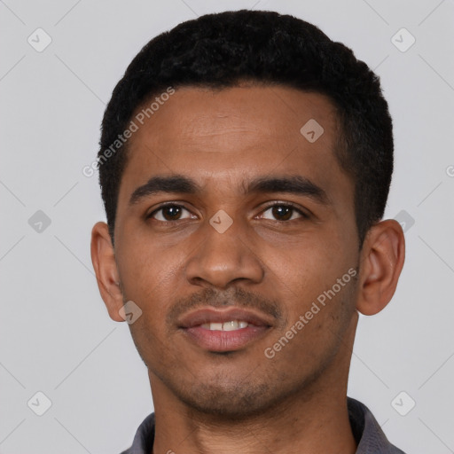 Joyful black young-adult male with short  black hair and brown eyes