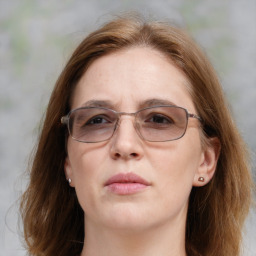 Joyful white adult female with medium  brown hair and blue eyes