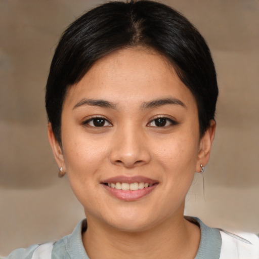 Joyful asian young-adult female with medium  brown hair and brown eyes