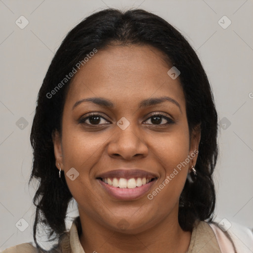 Joyful black young-adult female with long  brown hair and brown eyes