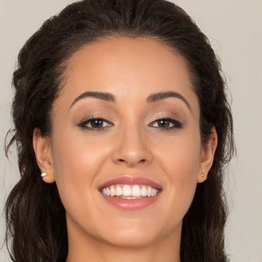 Joyful white young-adult female with long  brown hair and brown eyes