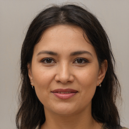 Joyful latino young-adult female with medium  brown hair and brown eyes