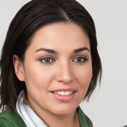 Joyful white young-adult female with medium  brown hair and brown eyes