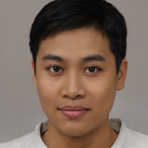Joyful asian young-adult male with short  black hair and brown eyes