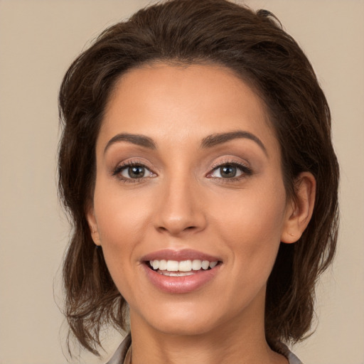 Joyful white young-adult female with long  brown hair and brown eyes