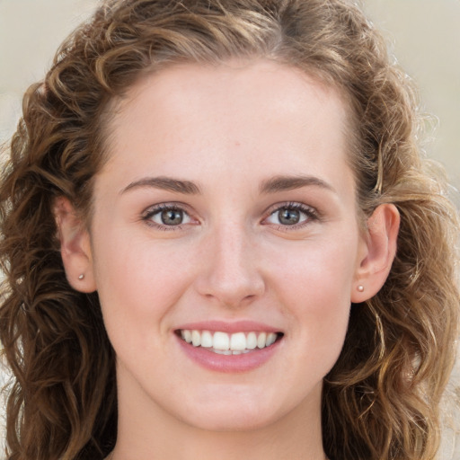 Joyful white young-adult female with long  brown hair and green eyes