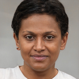 Joyful latino young-adult female with short  brown hair and brown eyes