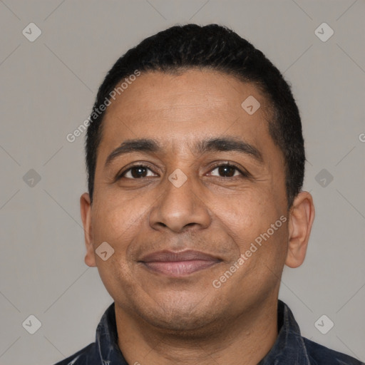 Joyful latino adult male with short  black hair and brown eyes