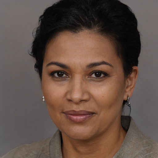 Joyful latino adult female with short  brown hair and brown eyes