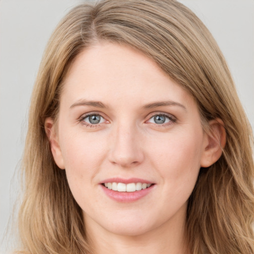 Joyful white young-adult female with long  brown hair and blue eyes