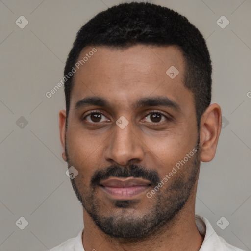 Joyful black young-adult male with short  black hair and brown eyes