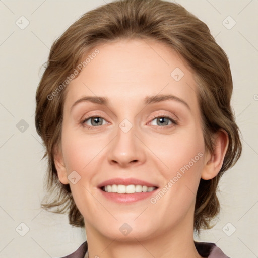 Joyful white young-adult female with medium  brown hair and green eyes