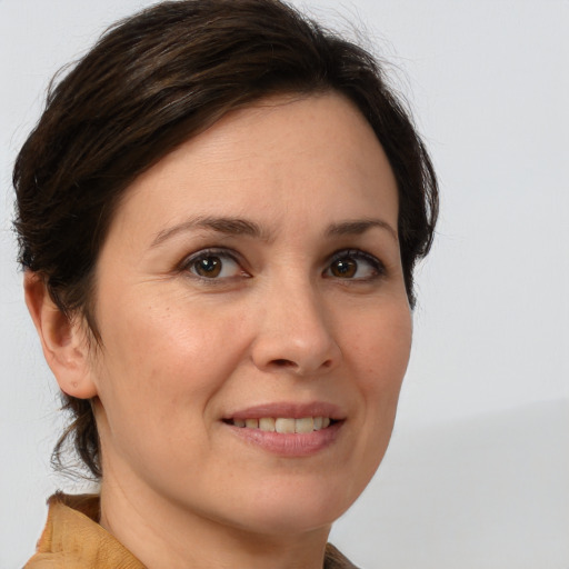 Joyful white adult female with medium  brown hair and brown eyes