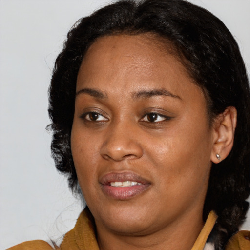 Joyful black adult female with medium  brown hair and brown eyes